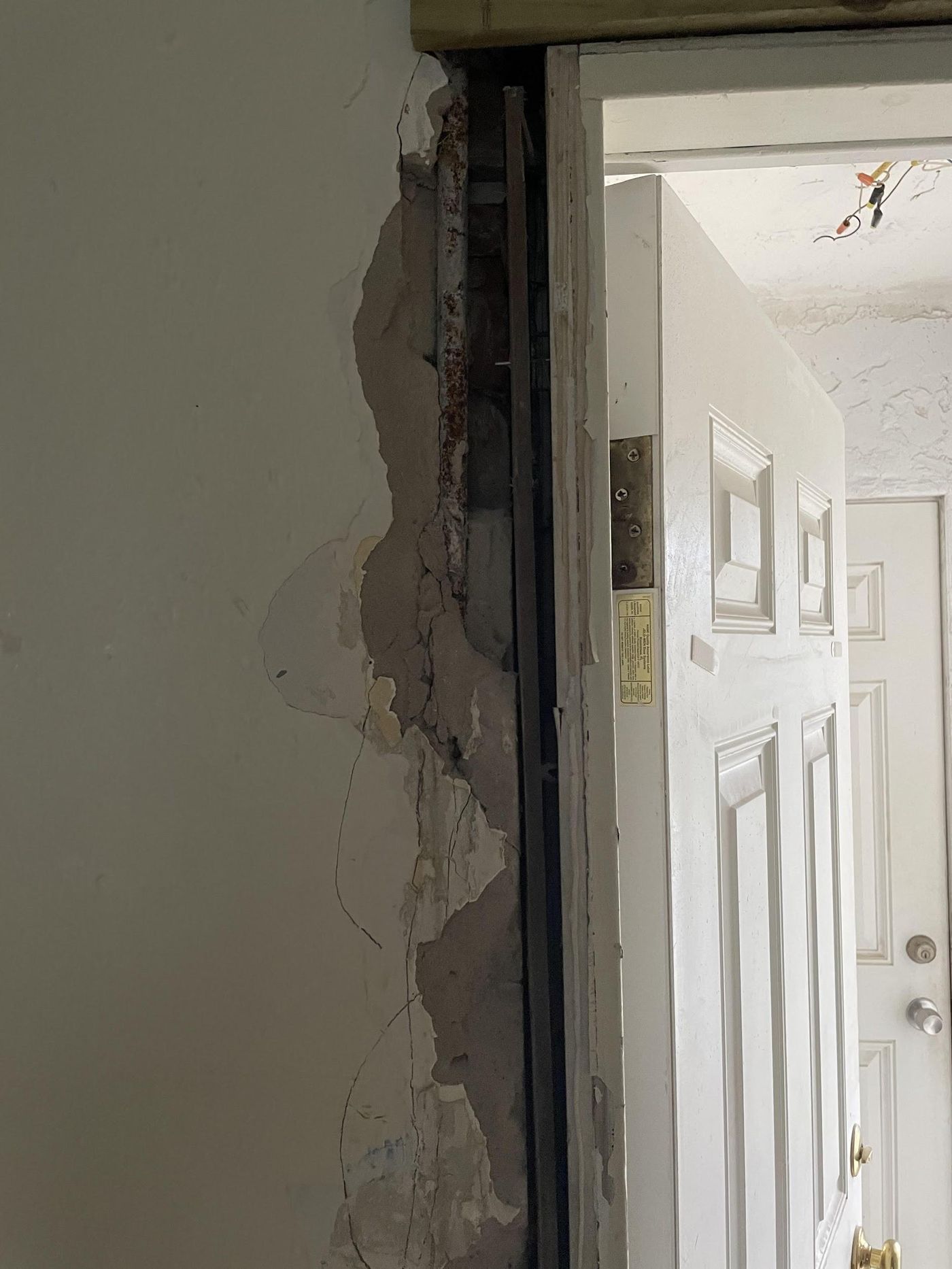 Broken masonry at door frame